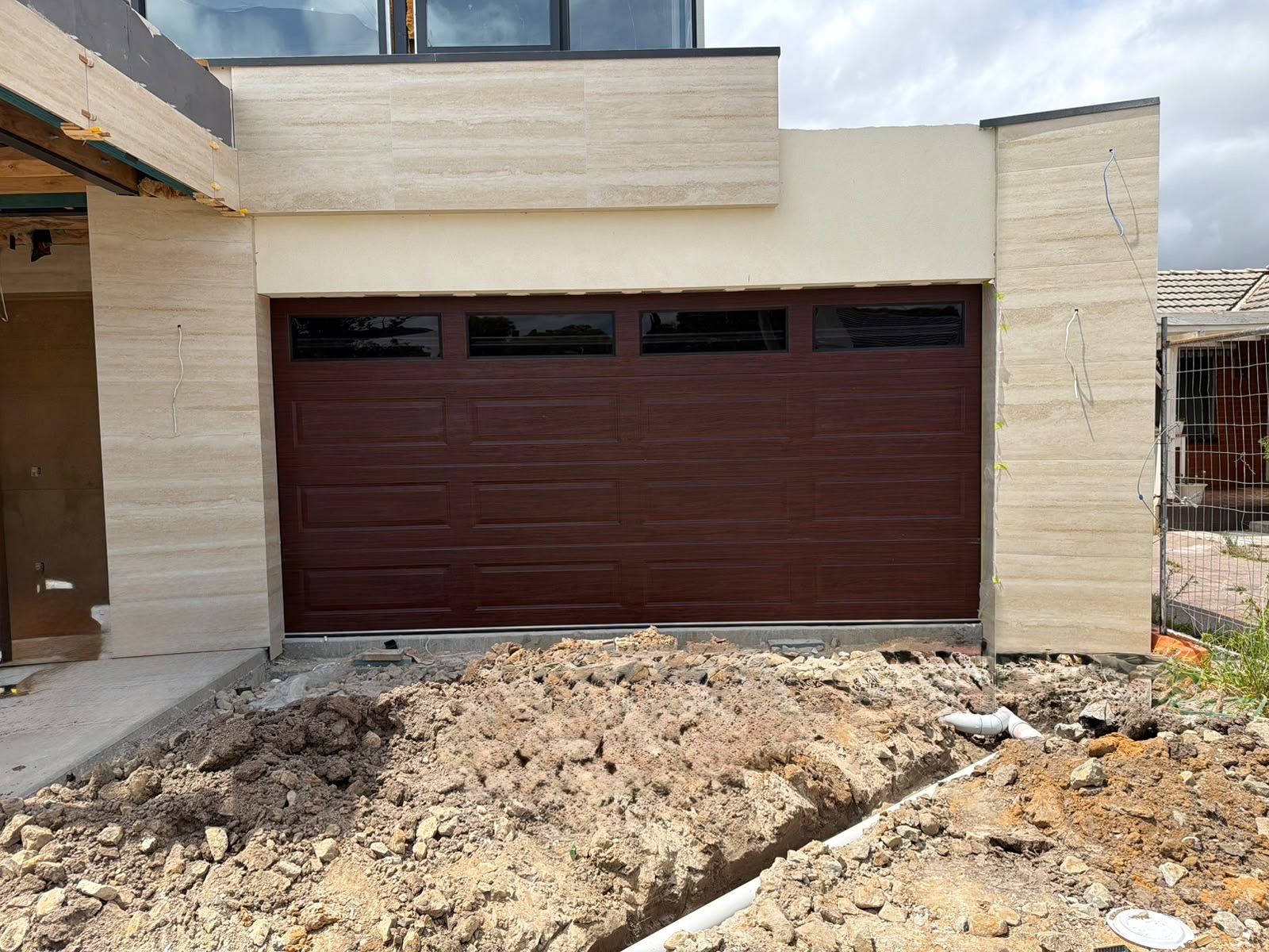 Woodgrain sectional garage door with window inserts